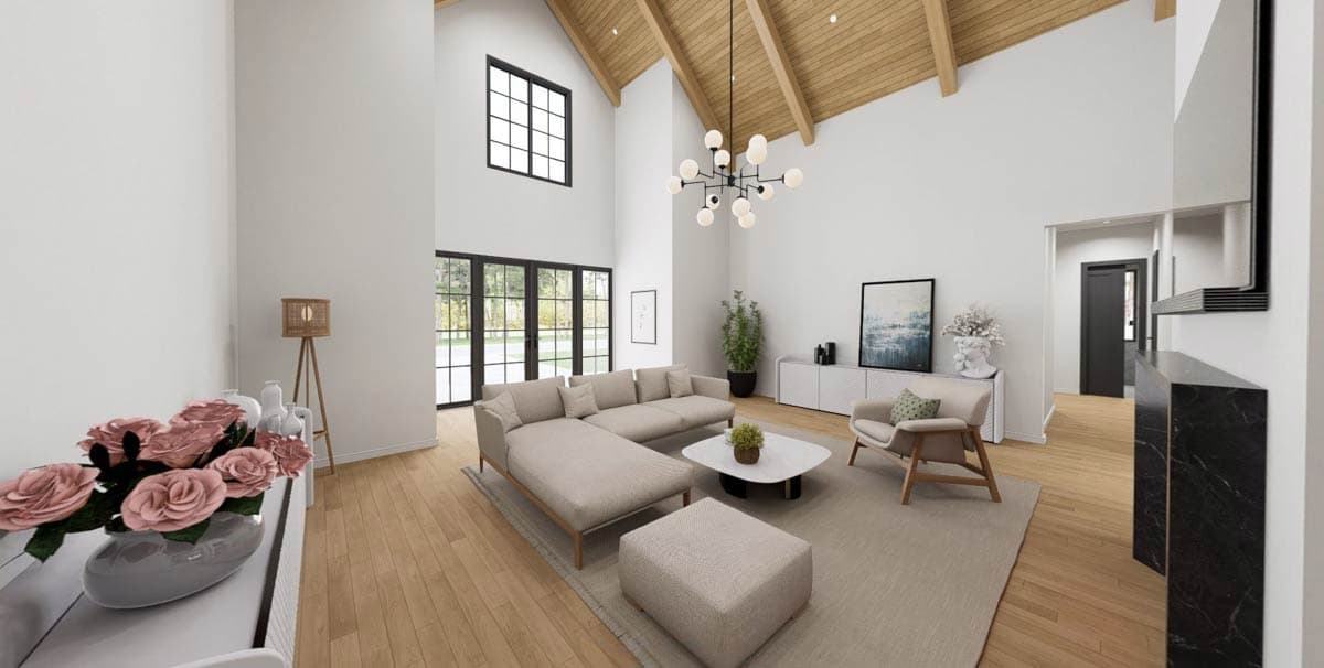 Interior rendering of a great room with vaulted wood-beamed ceiling, large window, and sectional sofa.