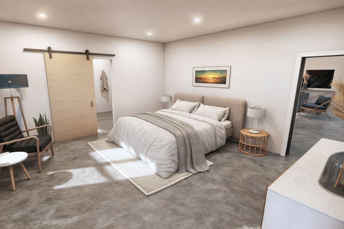 A modern bedroom with a large bed, a sliding barn door, and a cozy armchair. Soft light illuminates the neutral color palette.