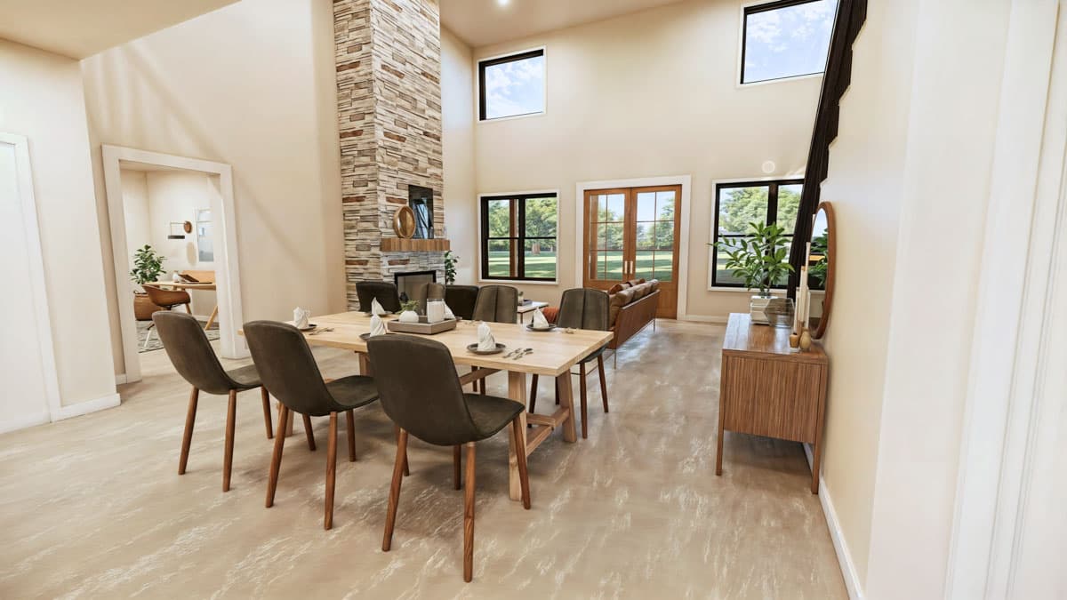 Great room with vaulted ceiling, stone fireplace, dining area, and large windows. Opens to a home office.