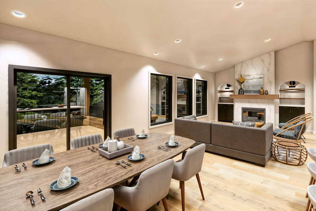 Spacious, modern dining and living area. Large sliding glass doors lead to an outdoor deck. The dining table is set for a meal.
