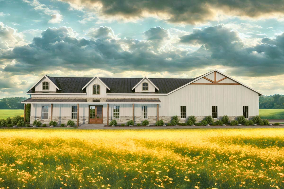 A large, white farmhouse with a dark roof and multiple dormers sits amidst a field of yellow wildflowers under a dramatic, cloudy sky.