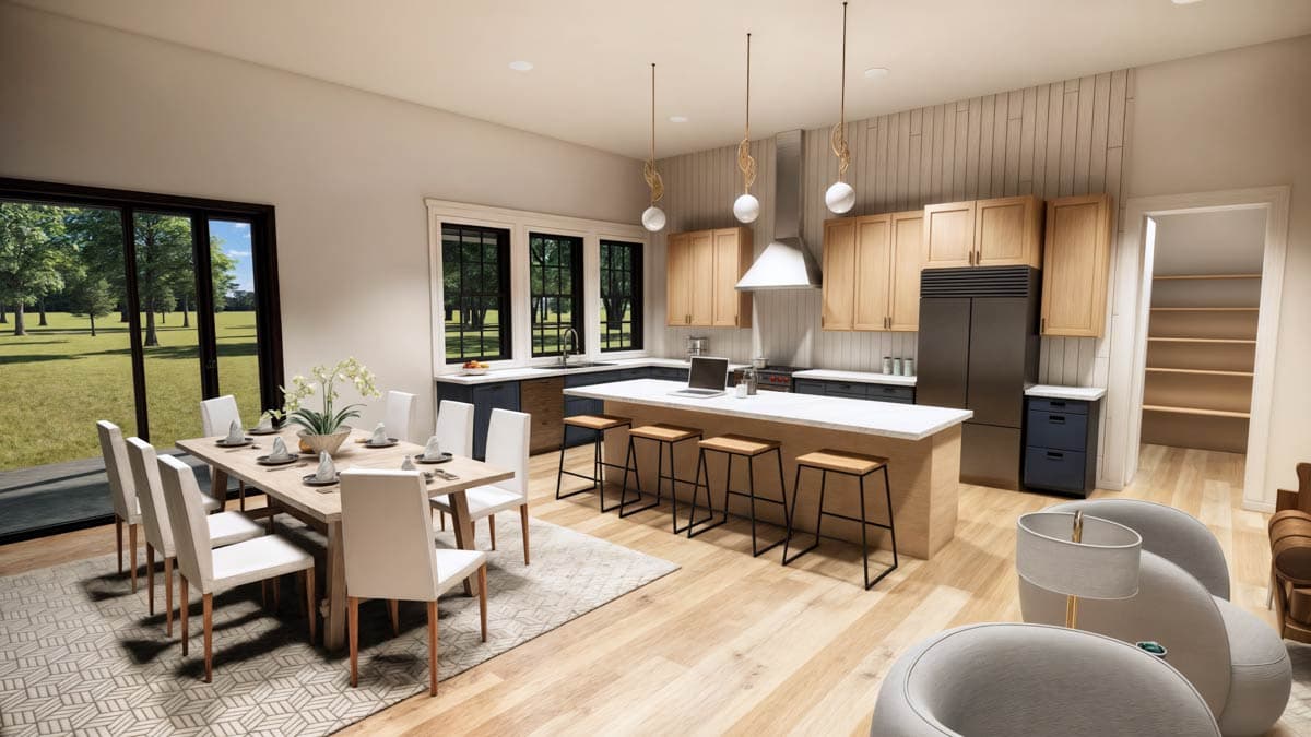 Modern open-concept kitchen and dining room with a large island, dining table set for guests, and large windows offering a view of the outdoors.