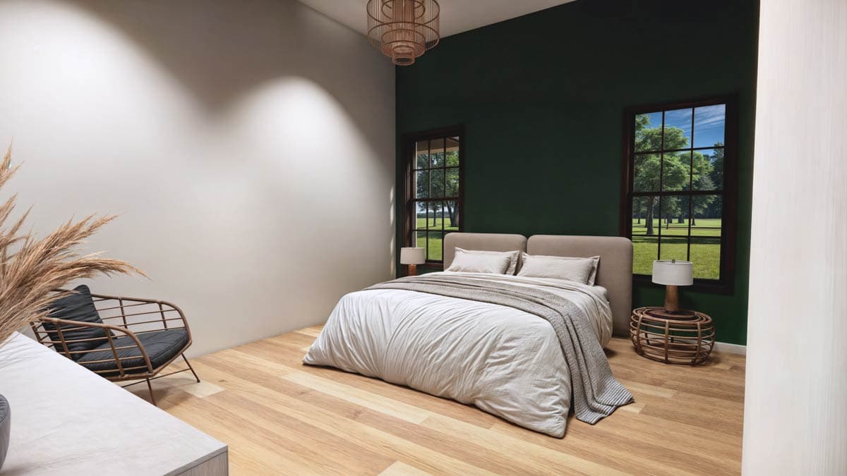 A modern bedroom with a bed, two windows overlooking a green landscape, and a chair. One wall is dark green, the other is white.