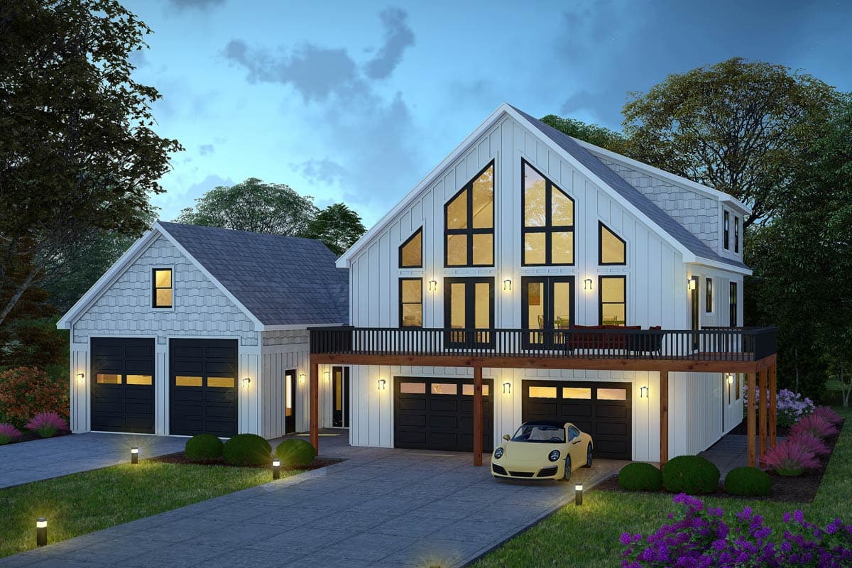 Modern farmhouse house plan exterior with a gabled roof, large triangular windows, a wraparound deck, and a three-car garage.