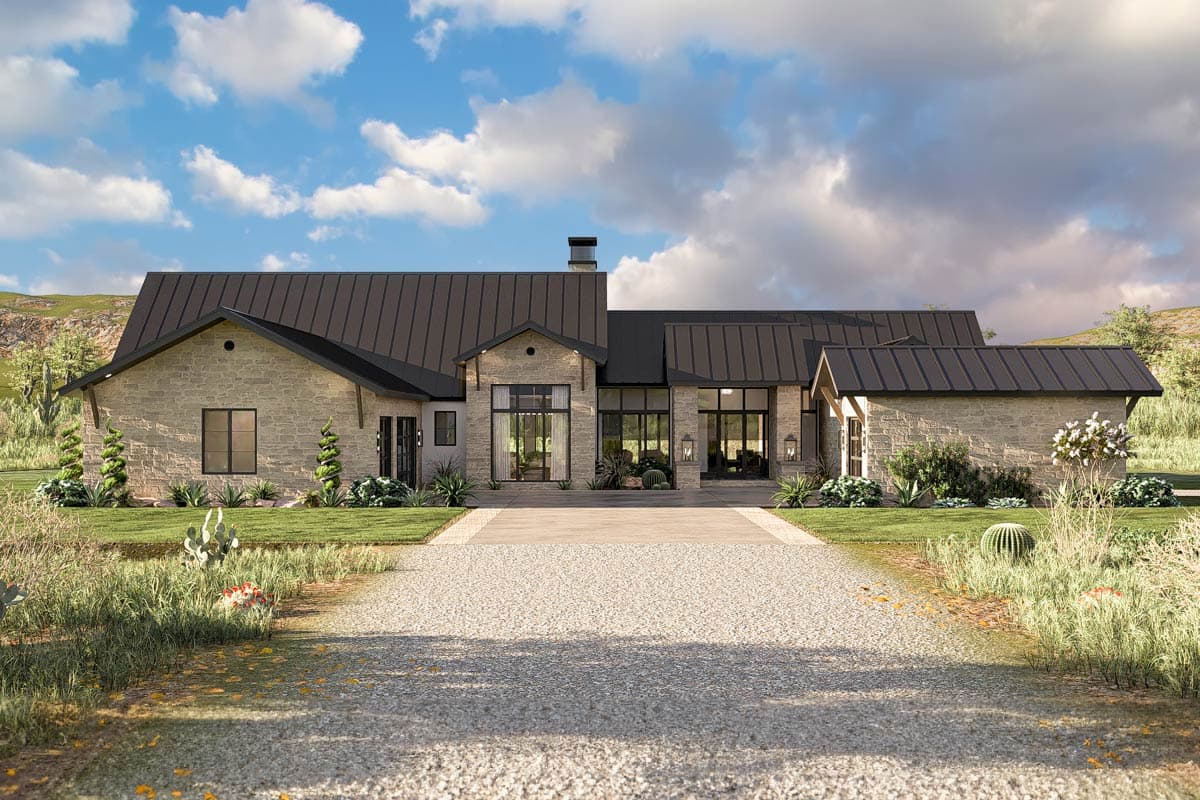 House plan exterior with stone veneer facade, metal roof, and gabled rooflines. Large windows and a long driveway are visible.