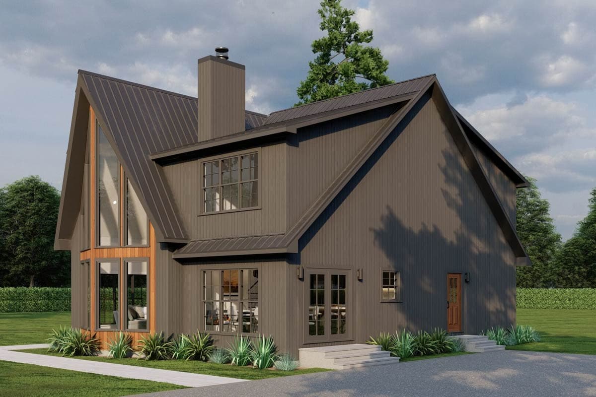 Modern house plan exterior with a steeply pitched metal roof, prominent chimney, and a two-story gable end with tall windows.