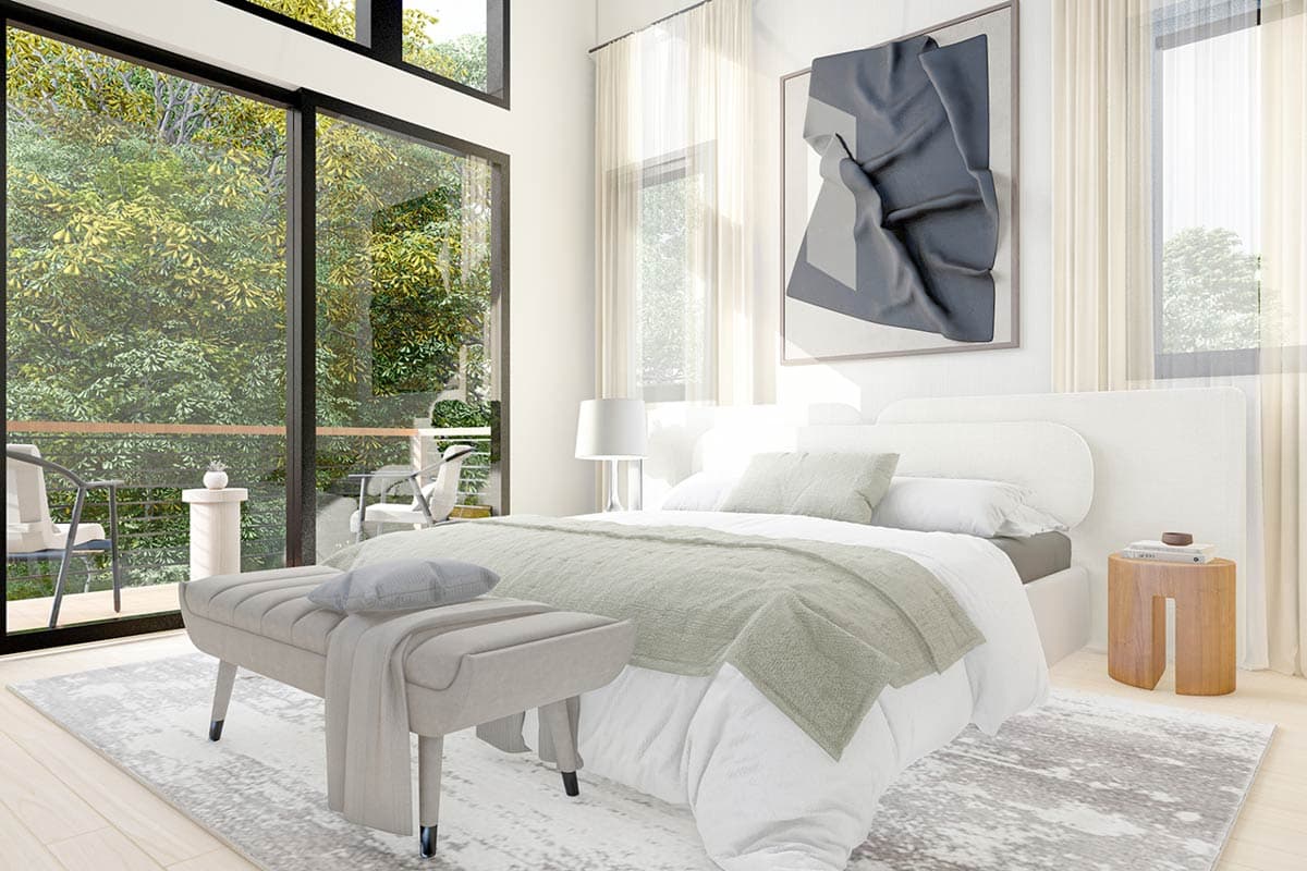 Primary bedroom with vaulted ceiling, large windows, and balcony access. Bed with upholstered headboard.