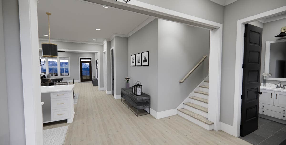 Interior rendering showing a hallway with stairs, kitchen island, and an open doorway to a bathroom.