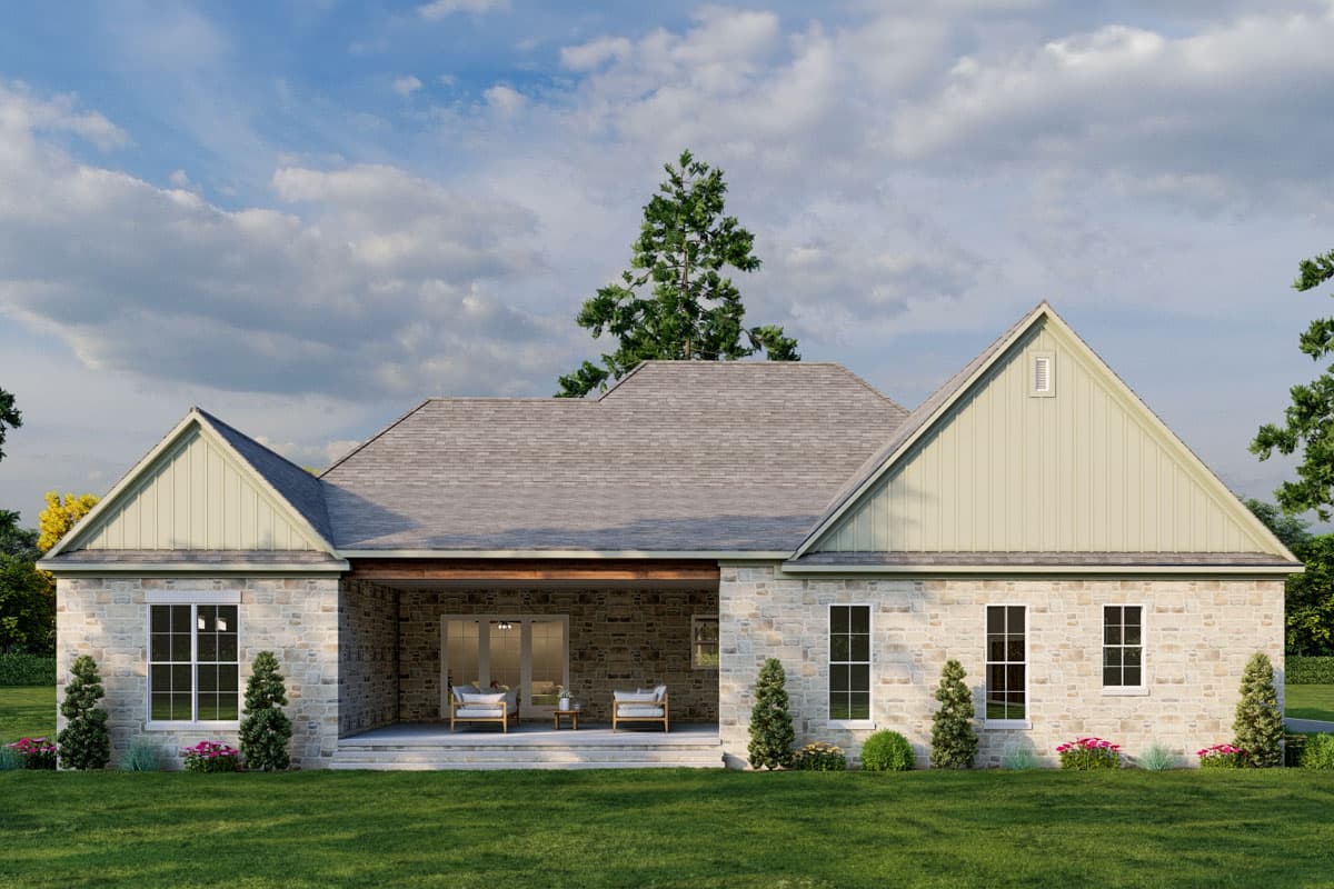 House plan exterior: One-story home with stone facade, covered rear porch, multiple gables, and hip roof.