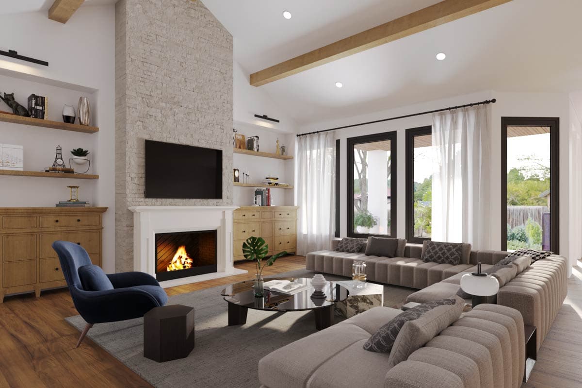 Living room with vaulted ceiling, stone fireplace, built-in cabinets, large sectional sofa, and floor-to-ceiling windows.