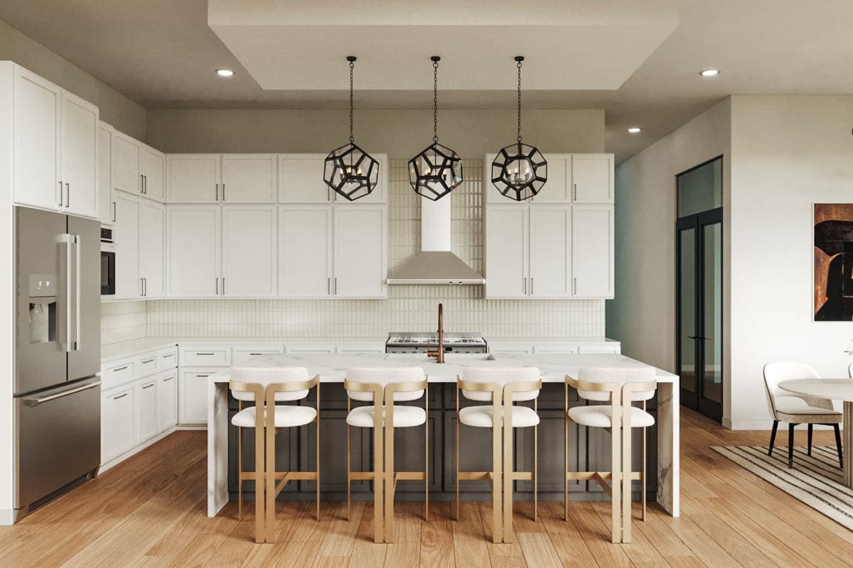 Modern kitchen with white shaker cabinets, stainless steel appliances, large island with seating, and geometric pendant lights.