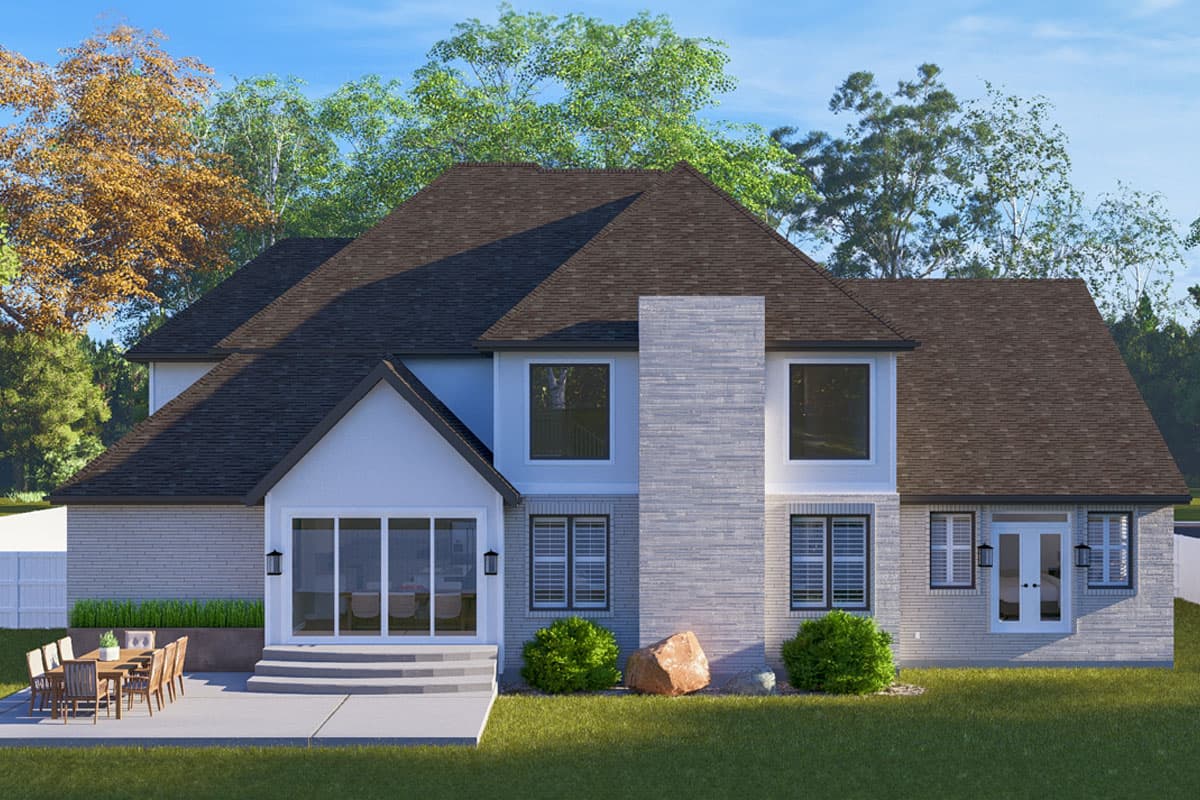 House plan exterior: Two-story modern home with brick and stucco facade, gable roof, large chimney, and patio.