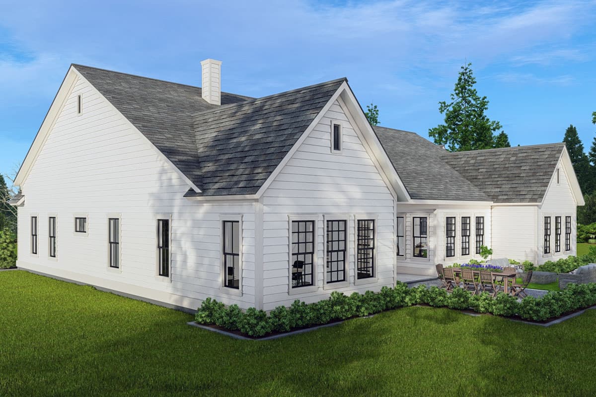 Modern Farmhouse house plan exterior with white siding, gables, prominent chimney, and numerous grid windows.