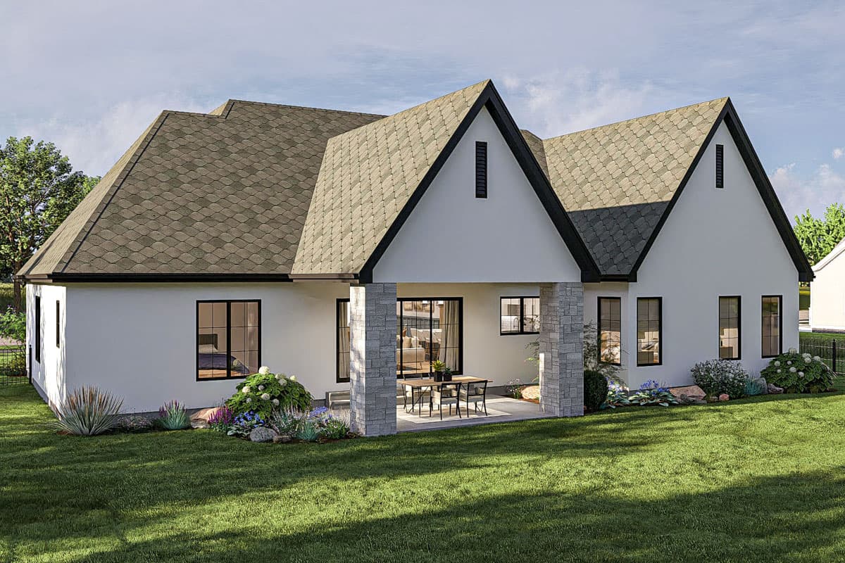 Modern Farmhouse house plan exterior with prominent gables, a covered patio with stone columns, and dark-trimmed windows.