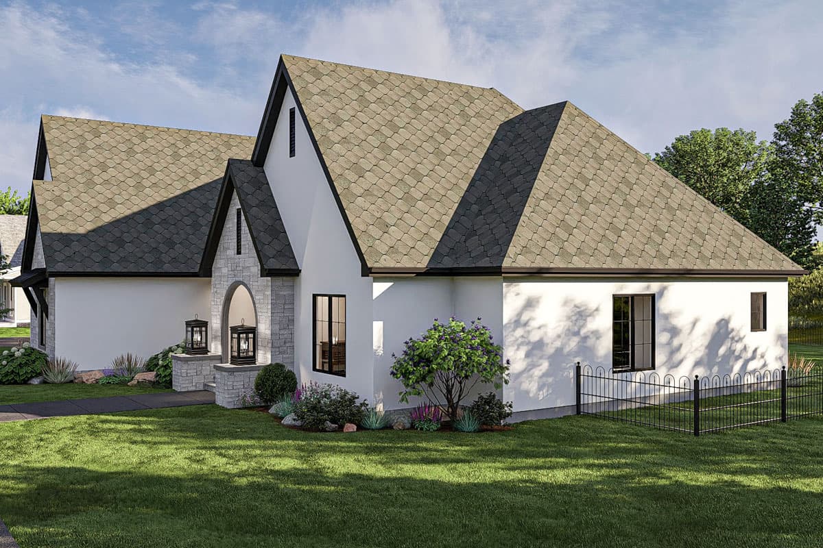 House plan exterior: single-story dwelling with prominent gables, arched stone entryway, and pitched rooflines.