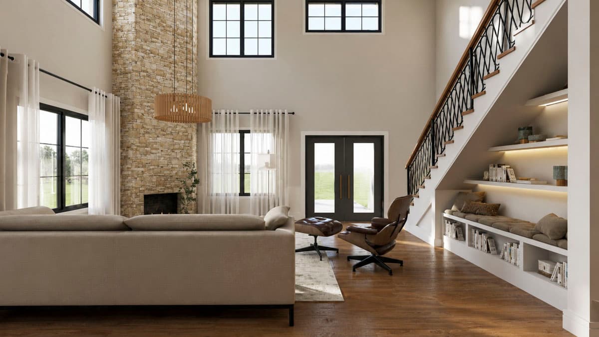 Open concept living area with two-story stone fireplace, double doors, and built-in bookcase under stairs.