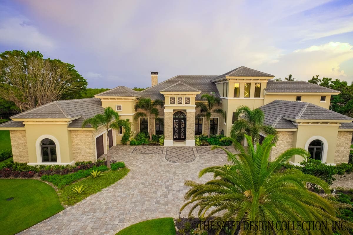 House plan exterior featuring a two-story design with a stone facade, arched windows, gabled rooflines, and a large front entrance portico.