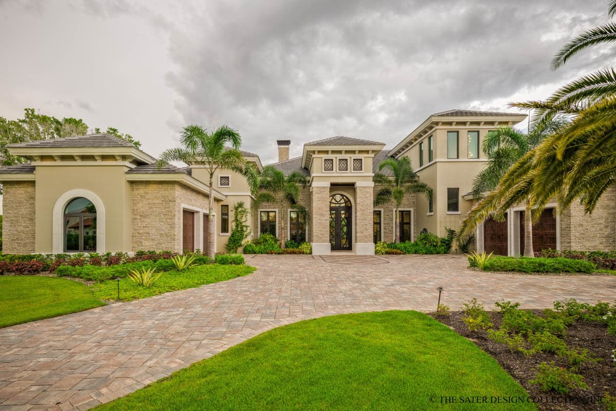 House plan exterior with stone accents, arched entry, multiple gables, and double garage doors.