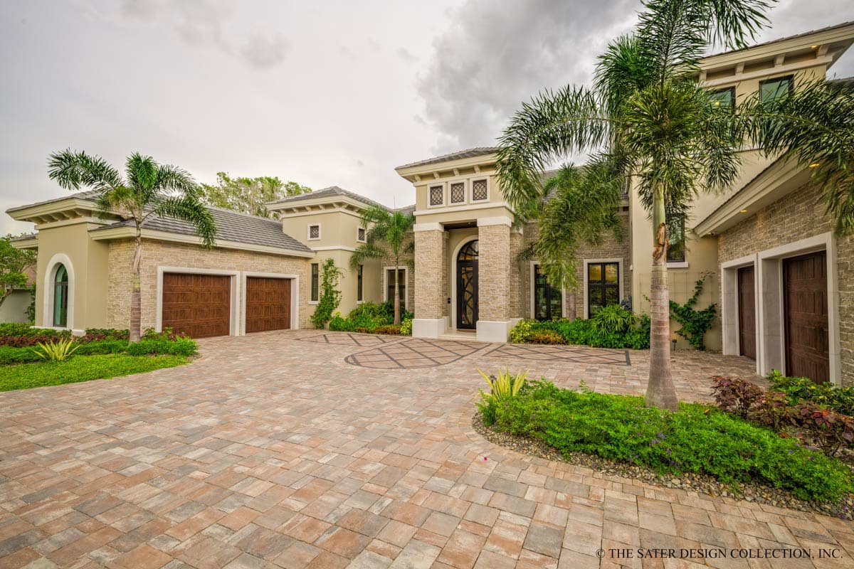 House plan exterior: Contemporary style, two-story residence with a three-car garage, arched entry, and stone accents.