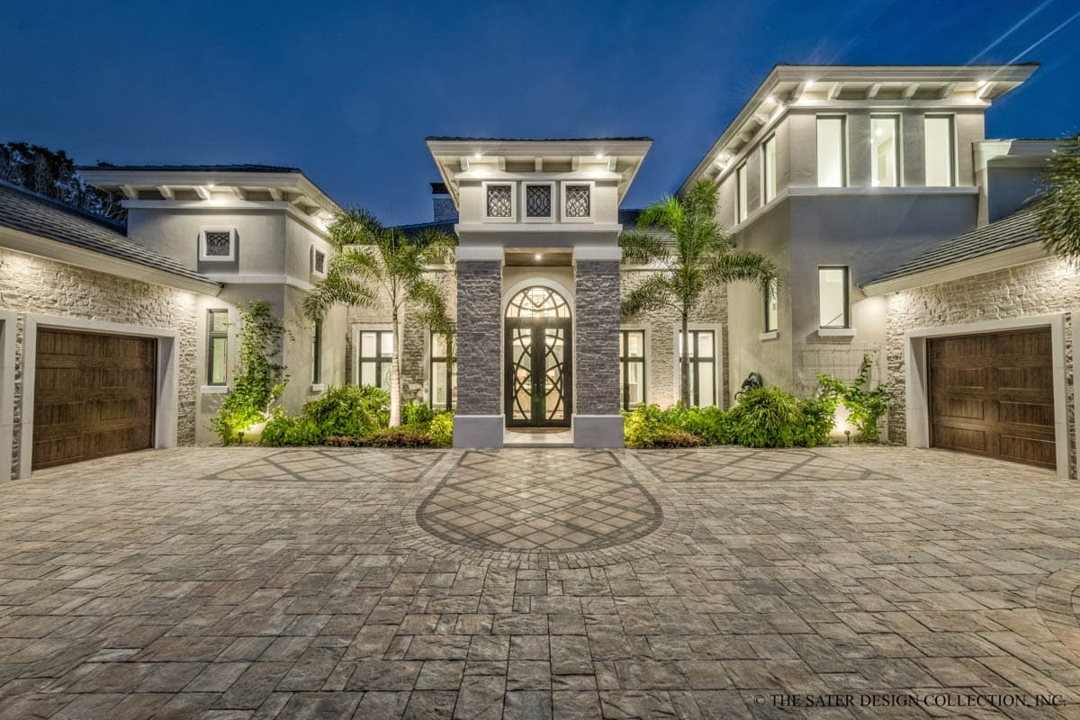 House plan exterior with two-car garage, stone accents, arched entryway, and multi-level rooflines.