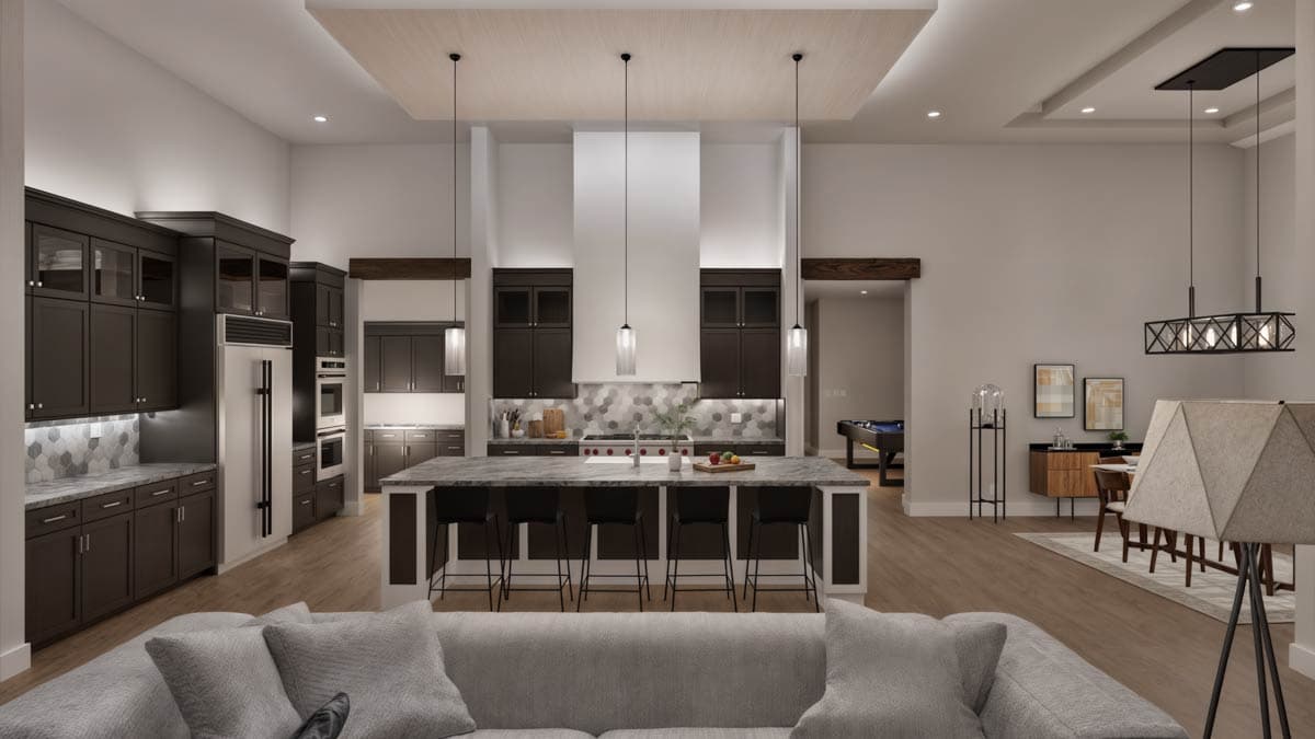 Interior view of a modern kitchen with dark cabinetry, large island, and open dining area. Visible pool table.