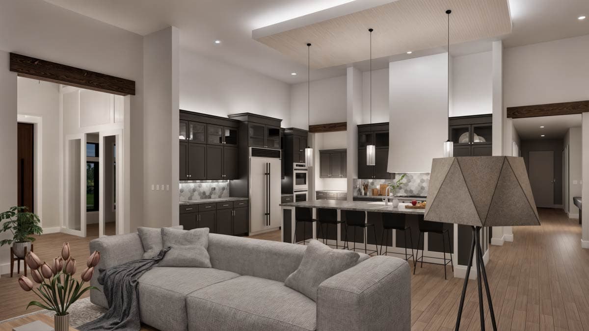 Open concept kitchen and great room with dark cabinetry, large island, and exposed wood beams.