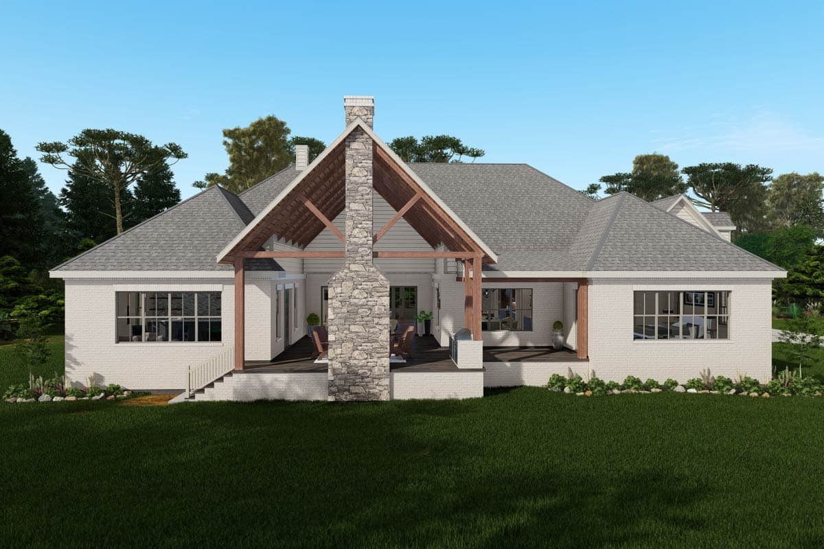 House plan exterior: one-story brick home with covered porch, exposed beams, stone chimney, and large windows.