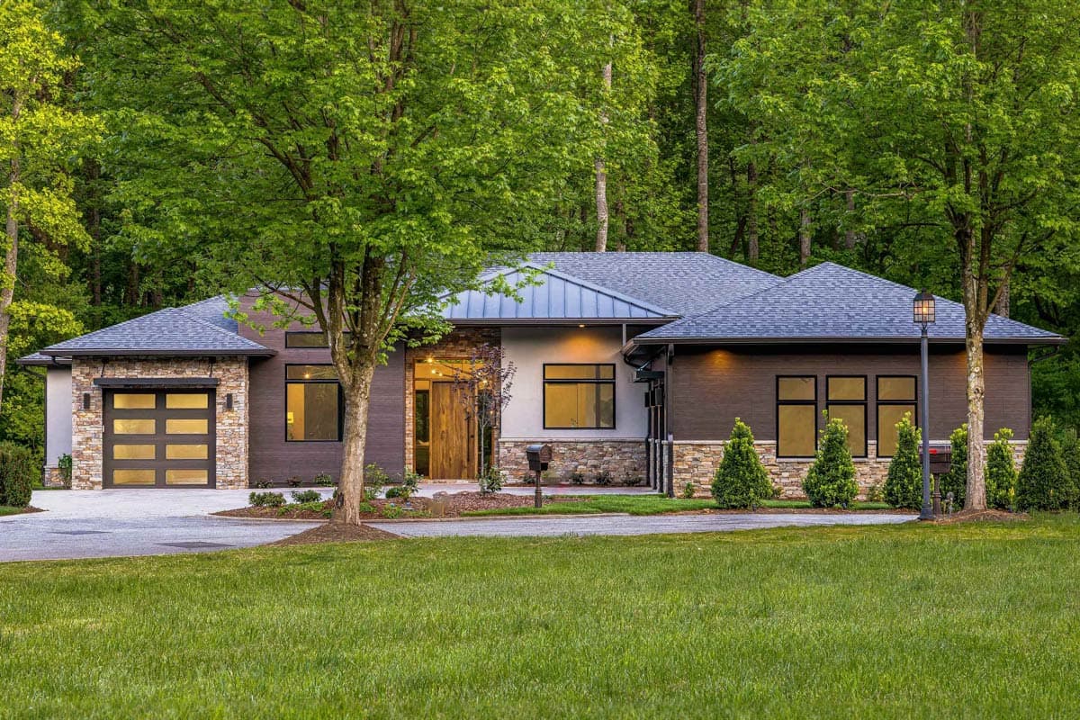Modern house plan exterior with stone and wood siding, multi-level roof, and glass garage door.