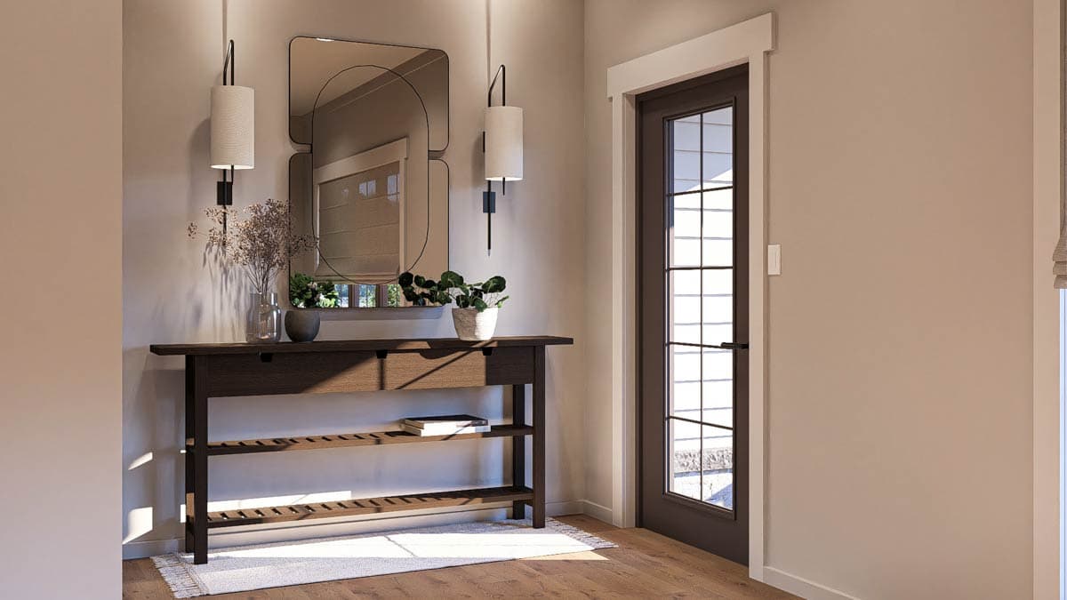 Interior view of a home entryway with a dark wood console table, a large mirror, and a glass-paned door.