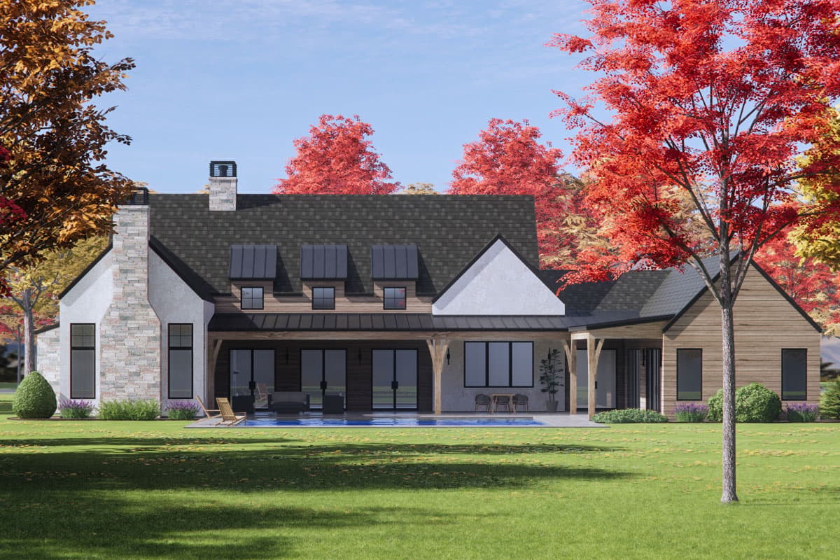 House plan exterior: Modern Farmhouse style with stone chimney, metal dormer windows, and covered patio.