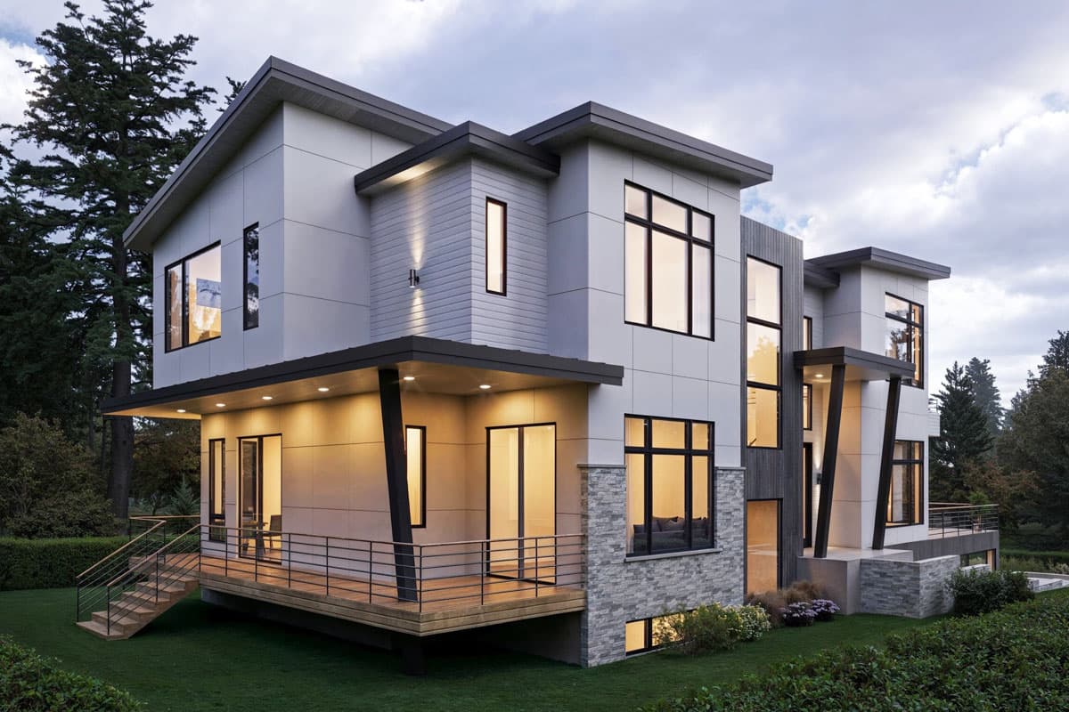 Modern two-story house plan exterior with angled rooflines, cantilevered decks, and large multi-pane windows.