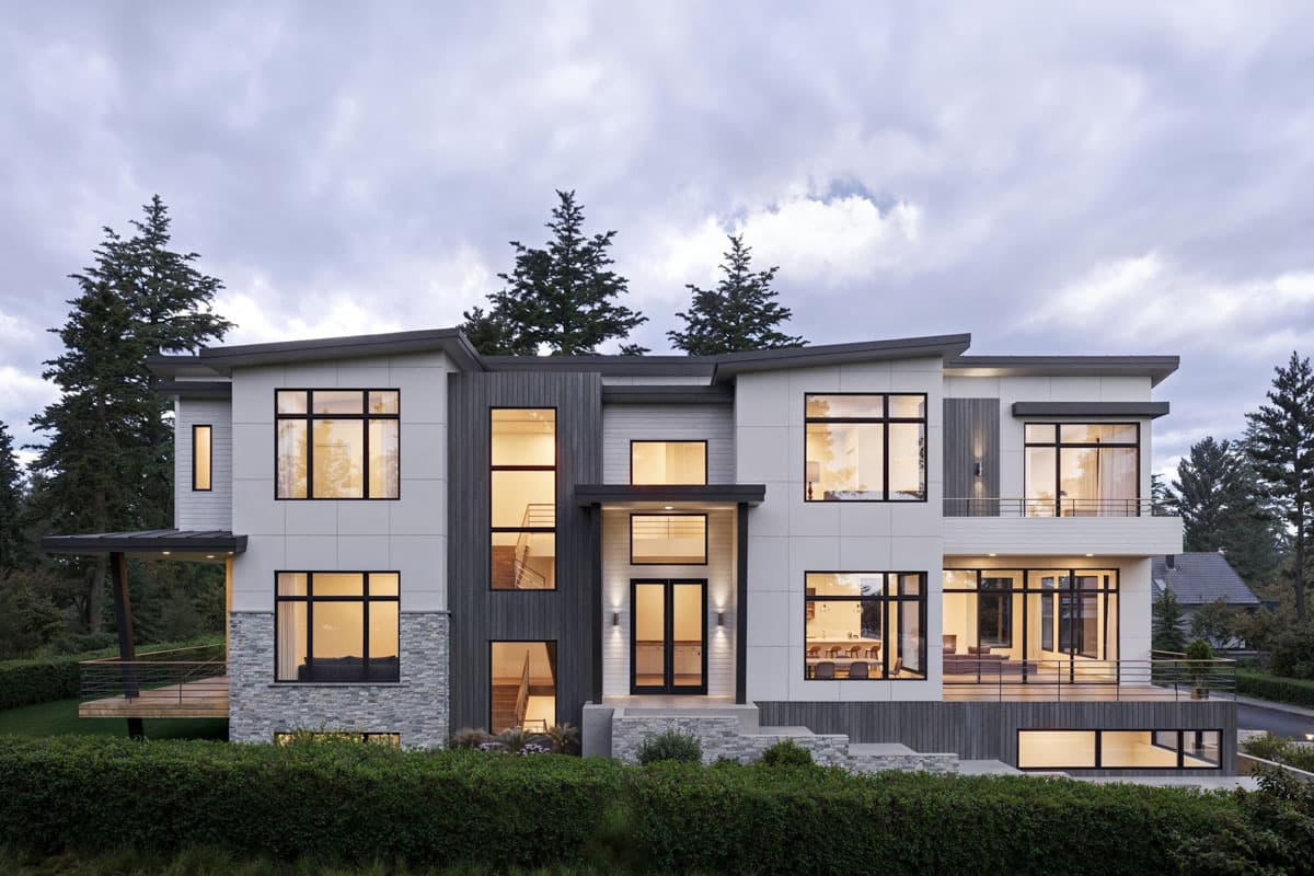 House plan exterior featuring a two-story Modern style with flat rooflines, large windows, and a combination of siding materials and stone veneer.