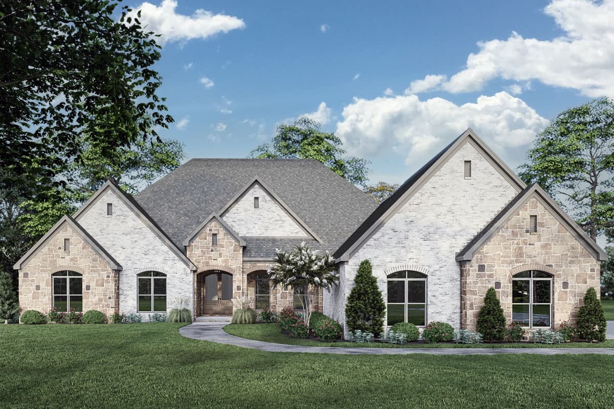 House plan exterior. One-story home with stone and brick facade. Features include multiple gables, arched windows, and a covered entry porch.