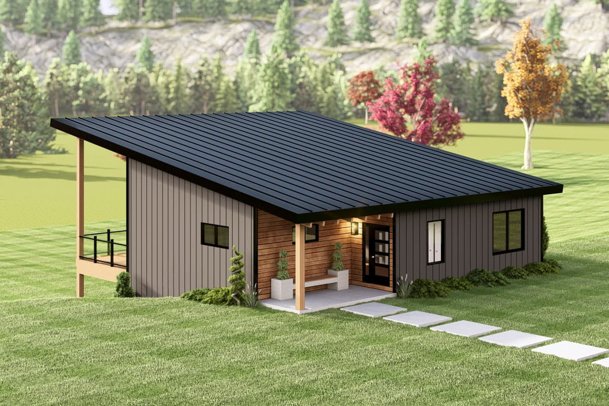 Modern, minimalist house with a dark metal roof and wood siding. A path of square stones leads to a covered entrance and bench, set on green grass.