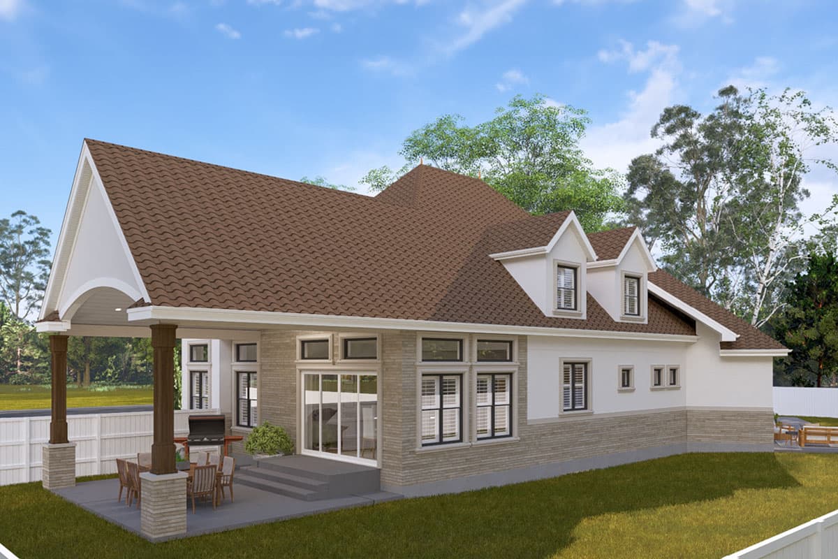 House plan exterior featuring a covered patio with outdoor dining, dormers, and a stone base.