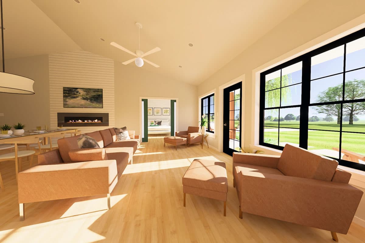 Living room rendering with fireplace, vaulted ceiling, fan, and large windows overlooking a lawn and trees.