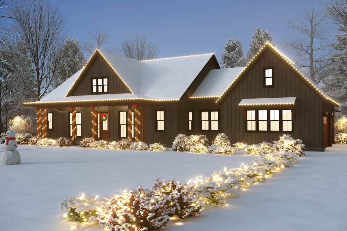 Modern Farmhouse house plan exterior with covered front porch, gables, and multiple windows on a snowy day.