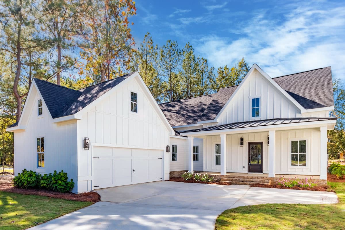 Modern farmhouse house plan exterior with two stories. Features include a front porch, gabled rooflines, and a side-entry garage.