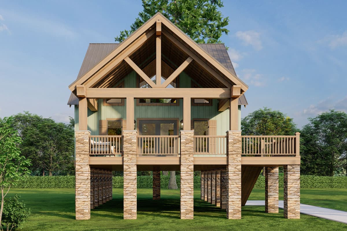 House plan exterior, two stories, elevated with stone piers, wooden beams, gabled roof, and wrap-around deck.