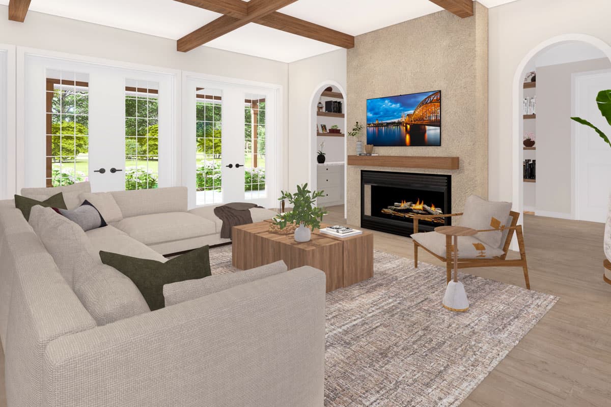 Living room with sectional sofa, fireplace, TV, wood-beamed ceiling, and French doors.