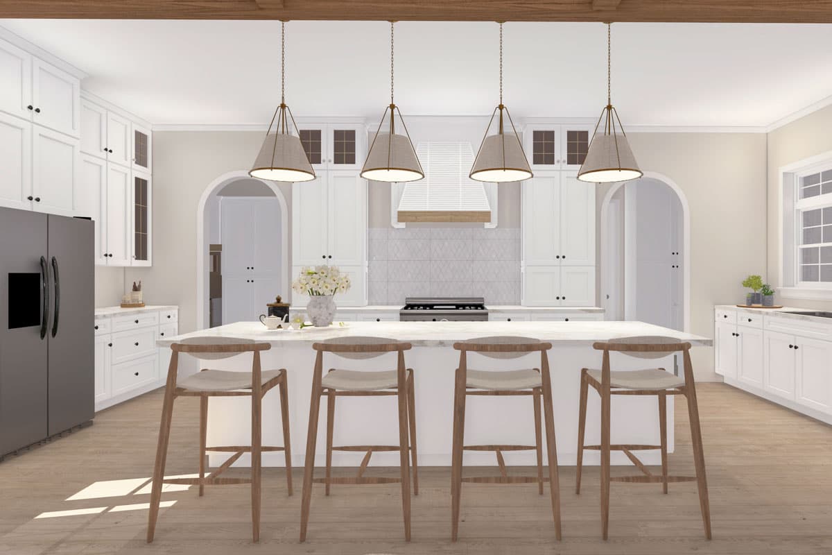White kitchen with large island, four pendant lights, paneled cabinets, stainless steel refrigerator and range.