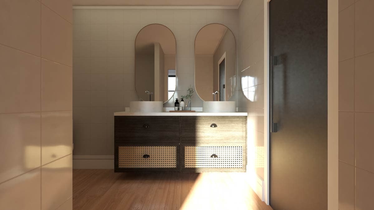 Bathroom vanity with double vessel sinks, dark wood cabinets, and cane detailing. Oval mirrors hang above the countertop.