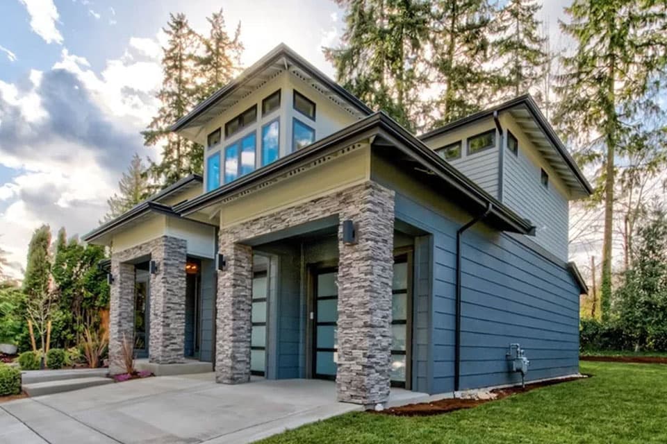 Modern house plan exterior with stone-clad columns, horizontal siding, and a multi-pane clerestory window.