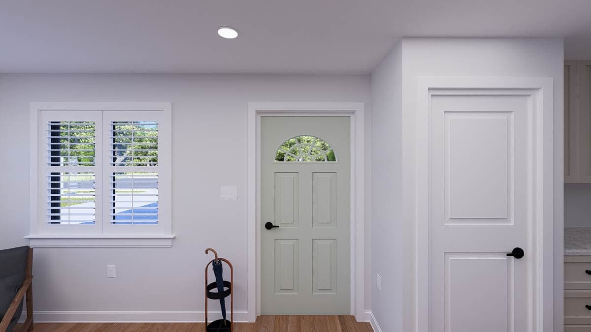 Interior view of a house plan showing a six-panel door with arched glass, plantation shutters, and a white door with paneled detailing.