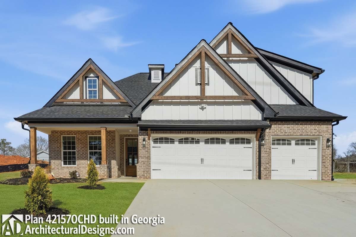 House plan exterior: Modern Farmhouse style, two stories, brick and board and batten, prominent gables with exposed rafter tails, and a three-car garage.