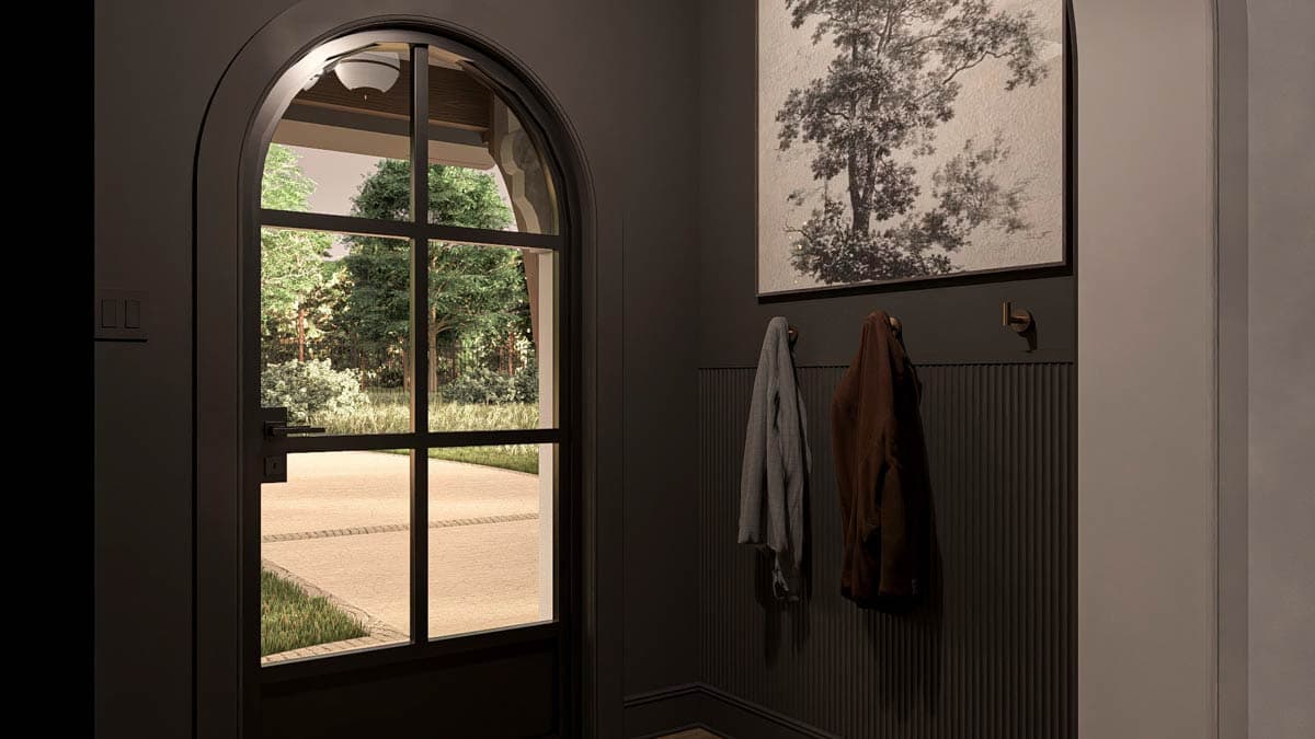 Interior view of a modern entryway with an arched multi-pane glass door, coat hooks, and a large tree artwork.