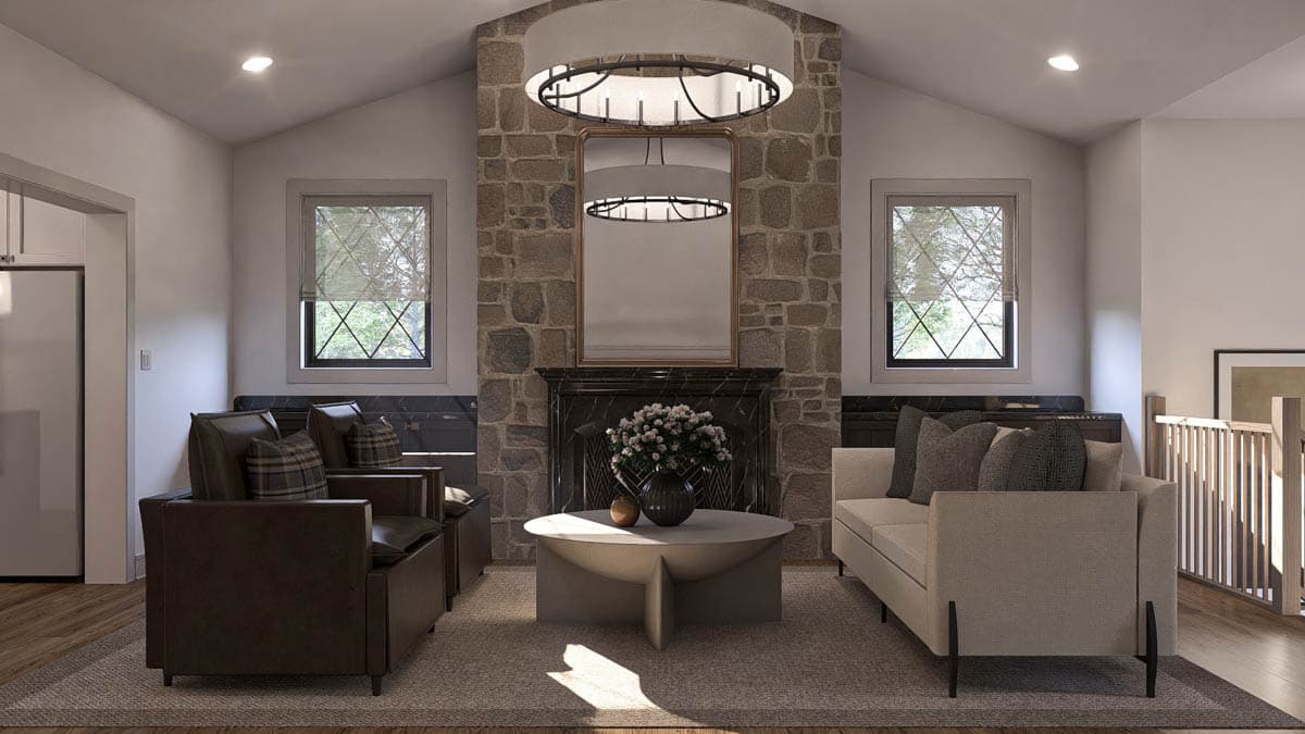 Living room with stone fireplace, vaulted ceiling, two windows, sofa, armchairs, and coffee table.