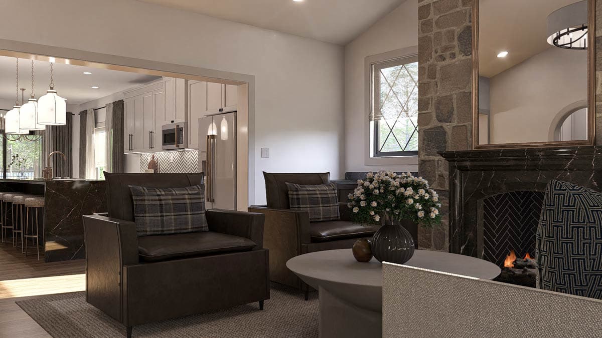 Living area with stone fireplace, vaulted ceiling, and view into a modern kitchen with island and pendant lighting.