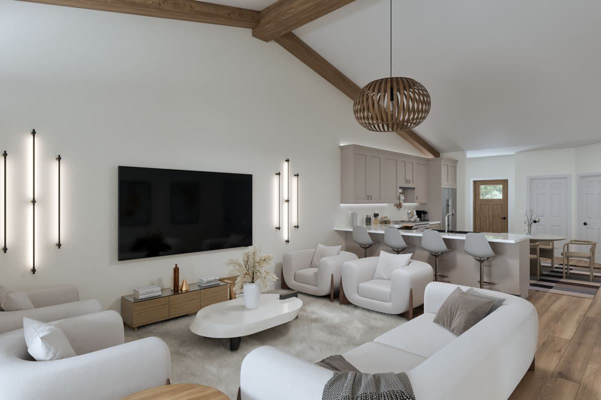 Open-concept living area with vaulted ceiling, exposed beams, large TV, kitchen island with bar stools, and dining nook.