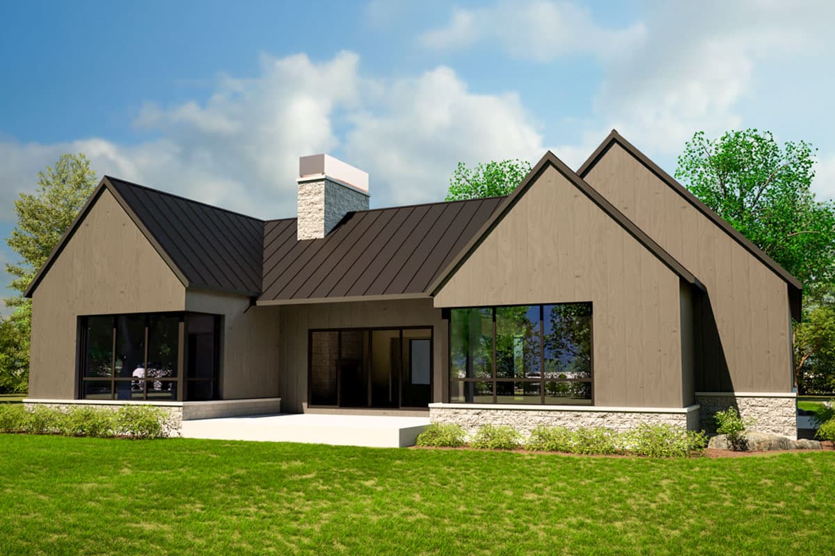 Modern house plan exterior with asymmetric gables, stone base, large windows, and dark metal roof.